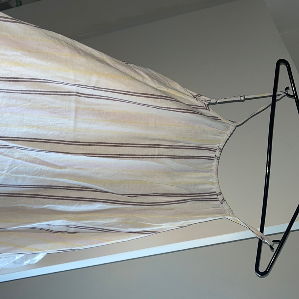 Cream colored maxi dress with brown and yellow stripes going down